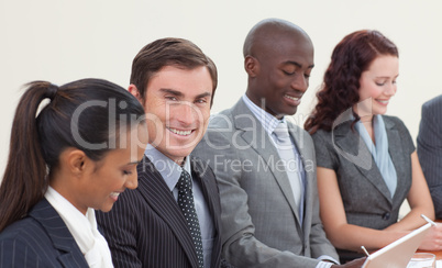 Smiling businessman working in a meeting