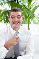 Businessman drinking a cup of tea in workplace