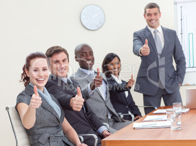 Businessteam with thumbs up after a presentation