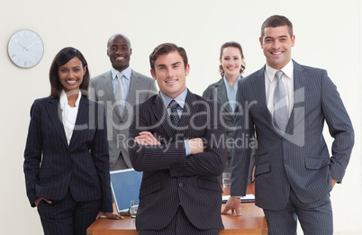 Confident business team standing in a meeting and smiling