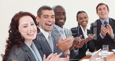 Happy businessteam clapping in a meeting