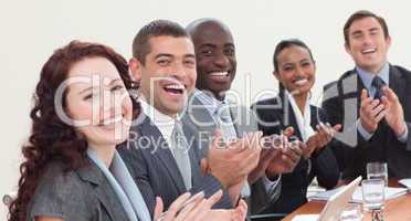 Happy businessteam clapping in a meeting