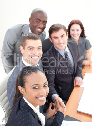 Smiling business team in a meeting shaking hands