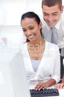 Businessman and businesswoman using a laptop