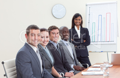 Businesswoman reporting to sales figures to her colleagues