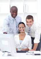 Businessmen and businesswoman using a laptop