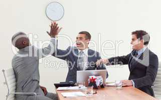 Businessmen in a meeting celebrating a success