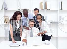 Business team working together with a laptop
