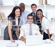 International businessteam using a laptop together