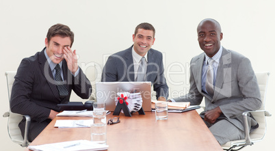 Businessmen in a meeting smiling at the camera