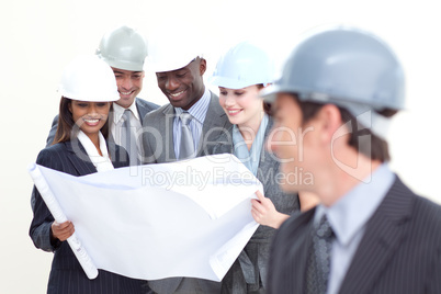 Engineer looking at his team studying a plan