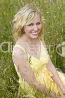 Blond Woman Sitting In Tall Grass