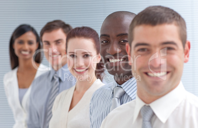 Business people in a line. Focus on an ethnic man