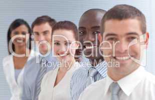 Business people in a line. Focus on an ethnic man