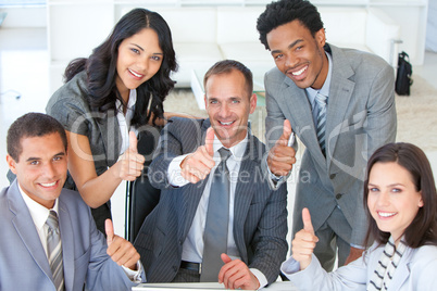 Business team with thumbs up in office