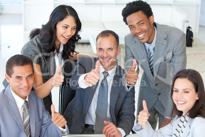 Happy businessteam with thumbs up in office