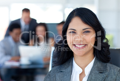 Beautiful businesswoman smiling with her team working in office