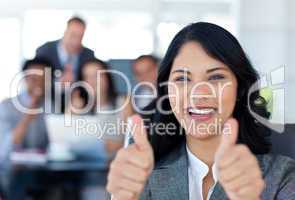 Portrait of a businesswoman with thumbs up in office