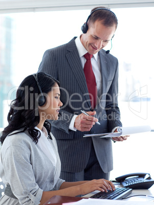 Manager talking to an ethnic businesswoman in a call center
