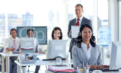 Male manager supervising his team in a call center