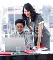 Businesswoman and businessman working in office