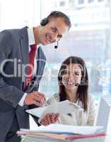 Manager working with businesswoman in a call center
