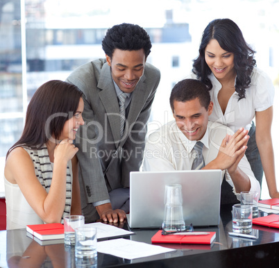 Multi-ethnic business team working together with a laptop