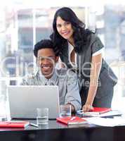 Businesswoman and businessman working with a laptop