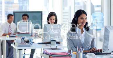 Businesswoman in a call center with her colleagues