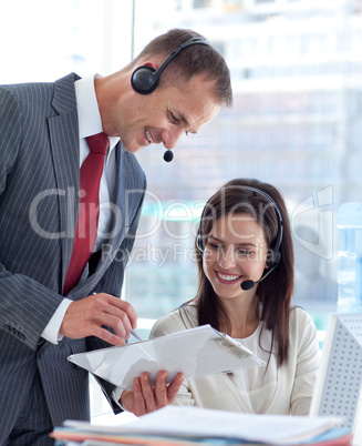 Manager talking to a businesswoman in a call center