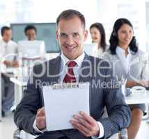 Male manager taking notes in a call center