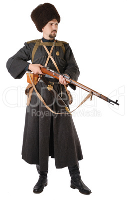 Man in vintage costume of Russian Cossack with a rifle.