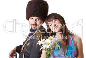Youth man in military and girlfriend with flowers.