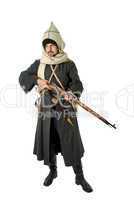 Man in vintage costume of Russian Cossack with rifle.