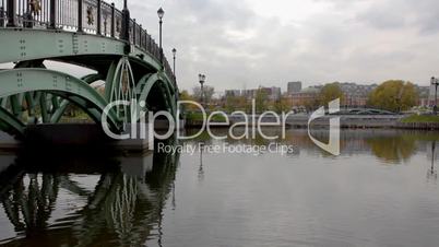Bridge over water in park with mirror