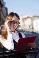 Young woman in glasses look at you and smile