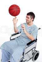 Patient in wheelchair spinning a basket ball on his finger