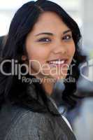 Portrait of friendly businesswoman in office smiling at the came