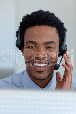 Afro-American young businessman in a call center