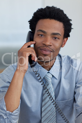 Portrait of Afro-American businessman on phone in office