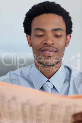 Afro-American businessman reading a newspaper