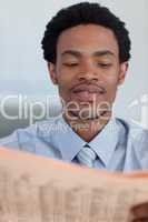 Afro-American businessman reading a newspaper