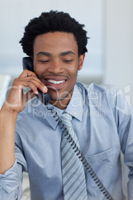 Afro-American businessman on phone in office