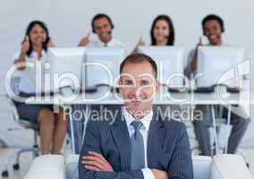 Manager in call center with his team with thumbs up