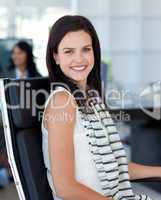 Smiling businesswoman sitting in her workplace
