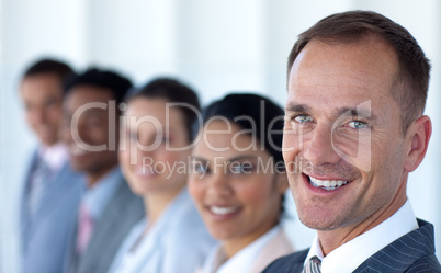 Attractive businessman in a row with his team