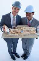 Engineers with hard hats holding a model house