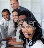 Portrait of a businesswoman in a call center with her team