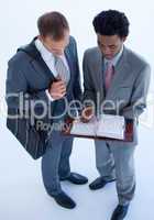Businessmen writing in a business diary