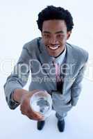 Smiling African businessman holding a glass of water